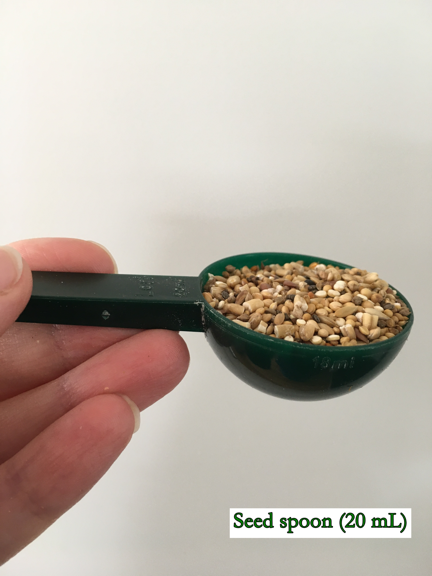 spoon (about 20 mL) used to measure seeds as an optional extra to freeze-dried chop, demonstrated here with the fine seed mix
