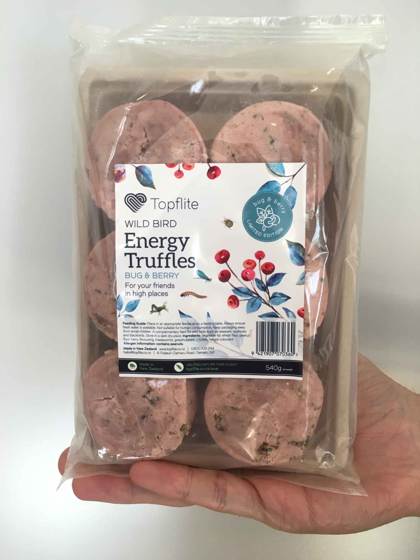 a pack of six truffles of bug and berry flavour, slightly pink, in packaging