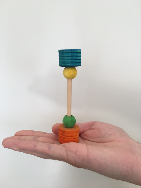 small foot bar bell is blue, yellow, green, and orange, and can stand vertically