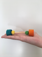 small foot bar bell fits in a palm of a hand