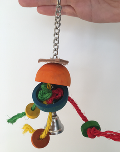 A hanging toy, with leather, a bell, some ropes, and a wooden ball that hangs open. You could place a treat inside and get your parrot to work out how to open it