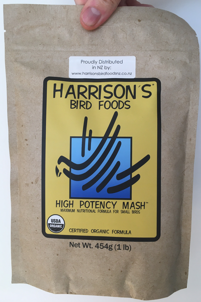 front of the small yellow bag of Harrison's High Potency Mash premium feed for small parrots, and doves, with higher nutritional needs