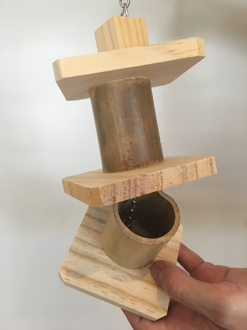 the bamboo toy showing one tumbler open where treats could be hidden