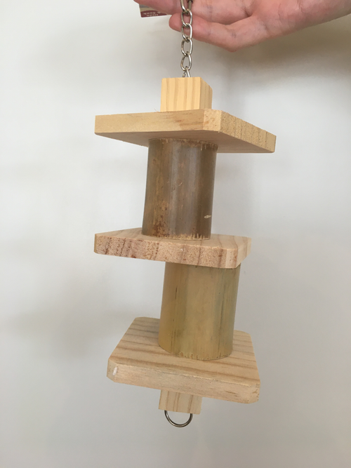 the bamboo toy in a natural hanging position