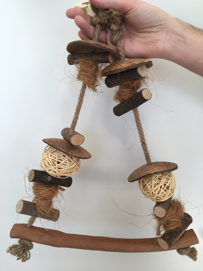 the swing has wooden pieces, coconut pieces, vine balls, and jute rope to hold it all together