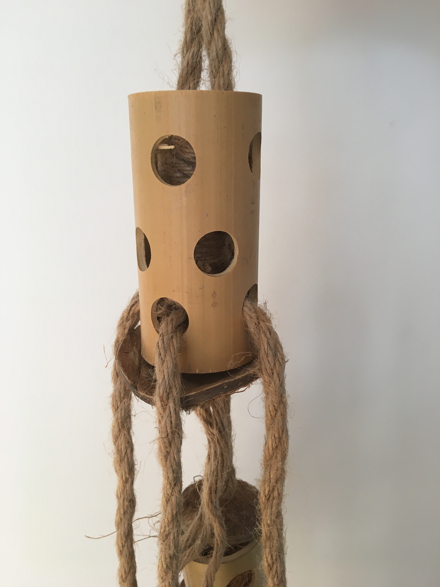 close up of the totem tower parrot toy - jute rope, wooden blocks, and coconut pieces