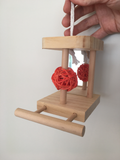 wooden perch with a mirror and a wicker ball
