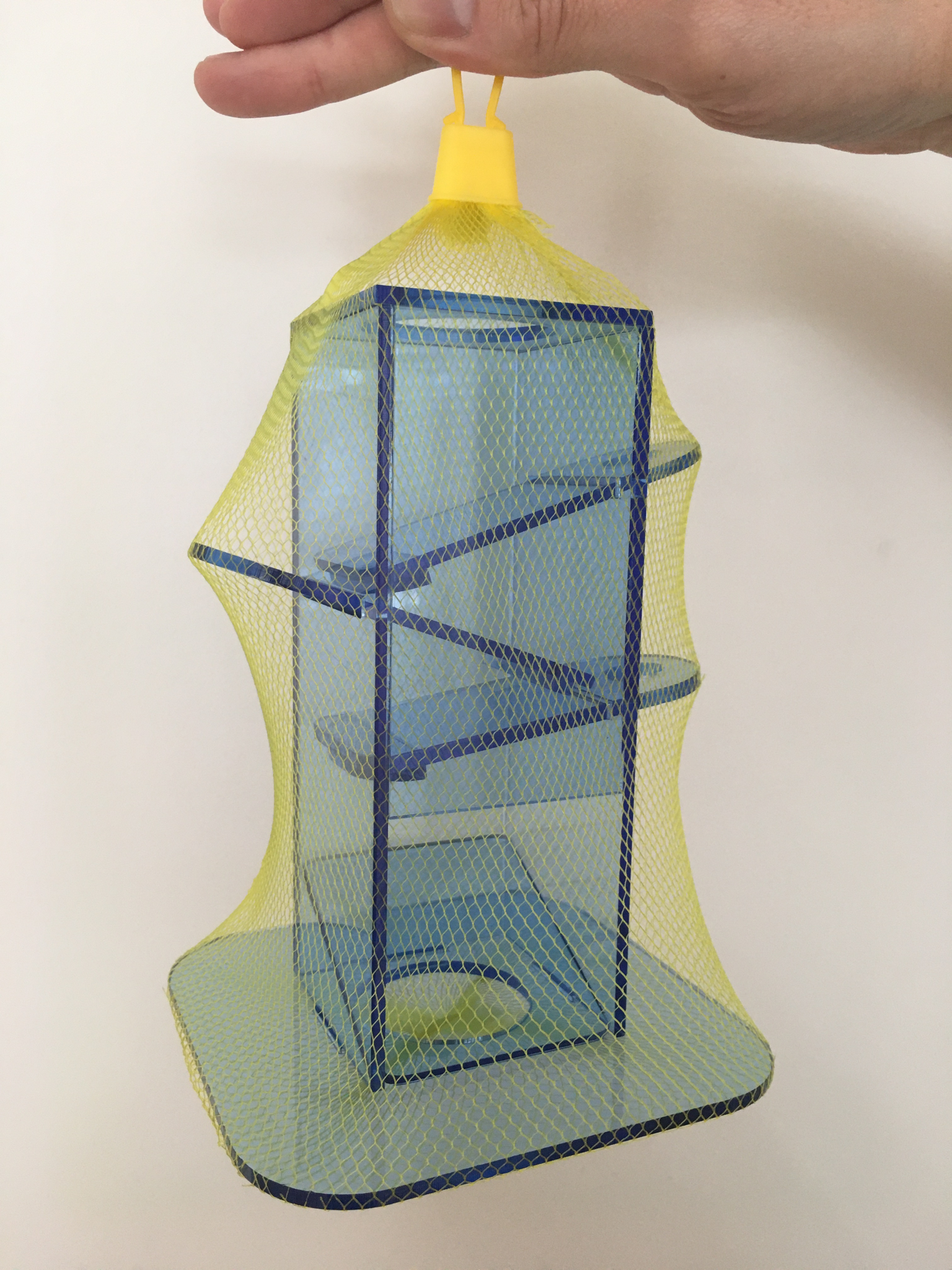 plastic toy in a yellow net to hold it together for shipping